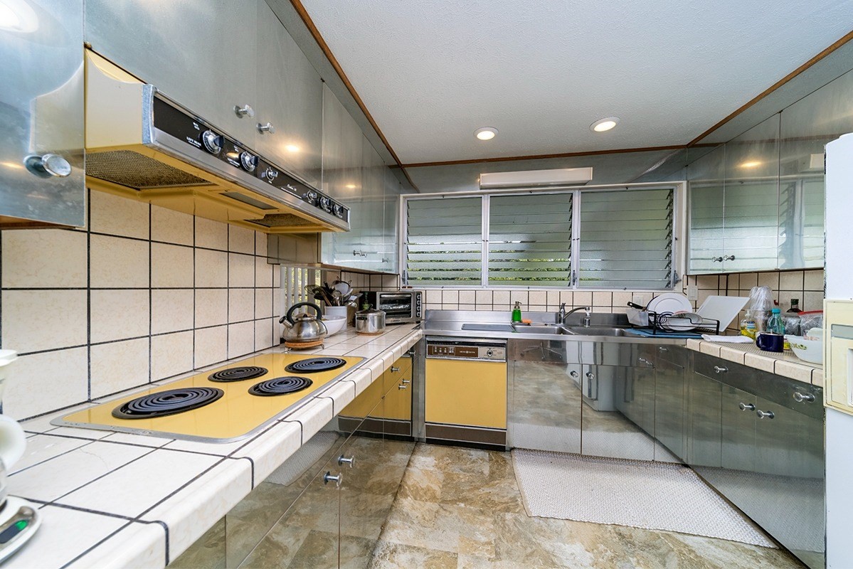 111 Hoaka Road Hilo, HI 96720 - Photo 12 of 21 a kitchen with a sink a counter and cabinets