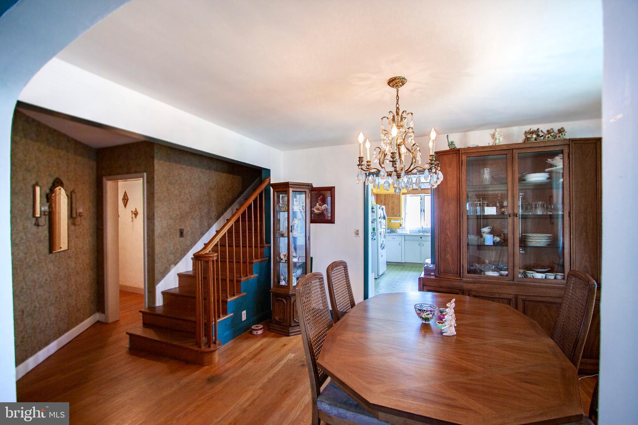 4703 Forge Road Perry Hall, MD 21128 - Photo 33 of 47 a view of a dining room with furniture a chandelier and wooden floor