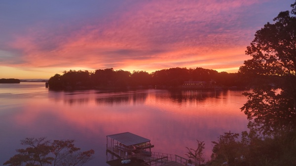 516 Hillandale Road Seneca, SC 29672 - Photo 43 of 50 Witness vibrant sunset hues reflecting over the tranquil lake with a private dock.