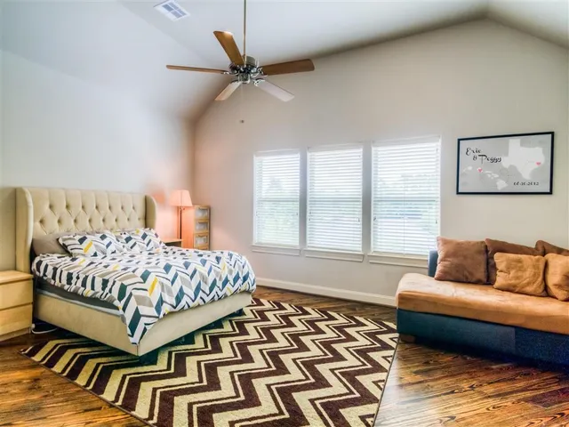 a bedroom with a bed and a couch