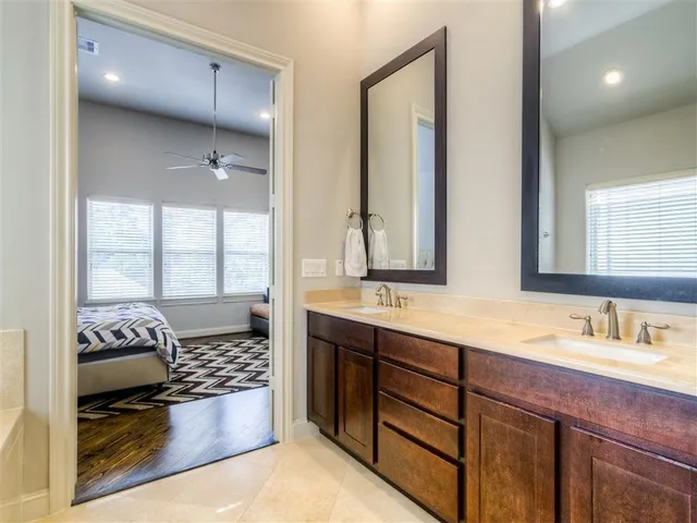 a bathroom with a tub sink and mirror