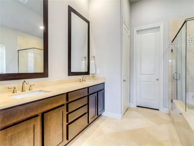 a bathroom with a double vanity sink mirror and