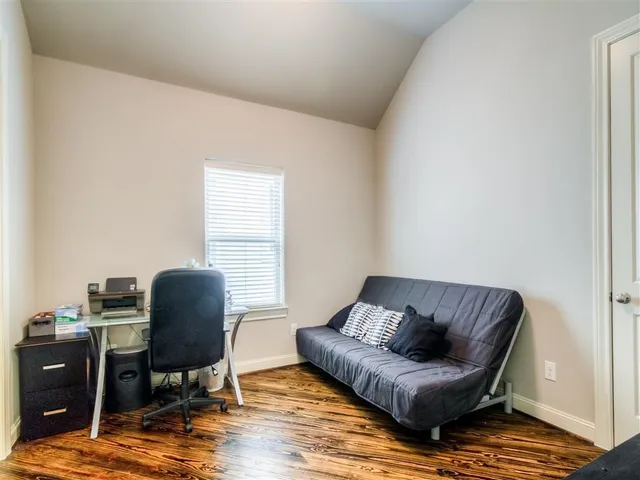 a living room with furniture rug and a window