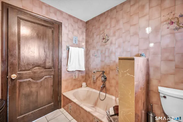 a living room with furniture flat screen tv and a fireplace