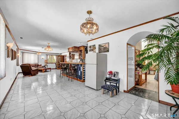 a view of a dining room with furniture and chandelier