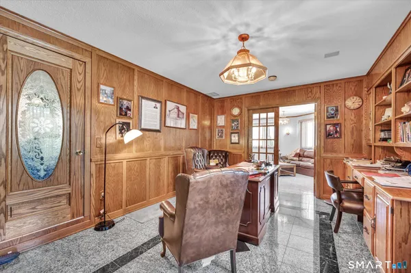 a view of living room filled with furniture and chandelier