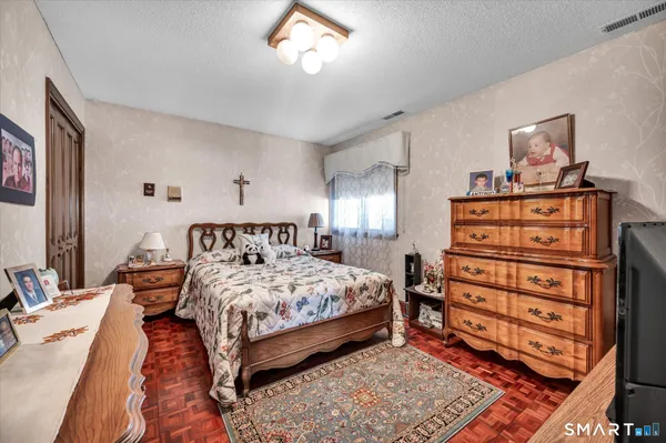 a room with painting and a potted plant