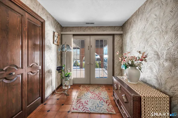 a utility room with a cabinet and a rug