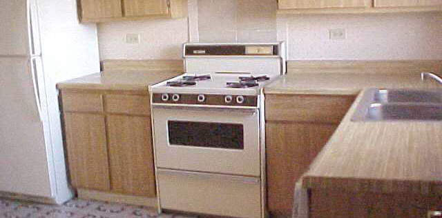 99 East Dundee Road Wheeling, IL 60090 - Photo 2 of 5 a kitchen with a stove top oven and cabinets