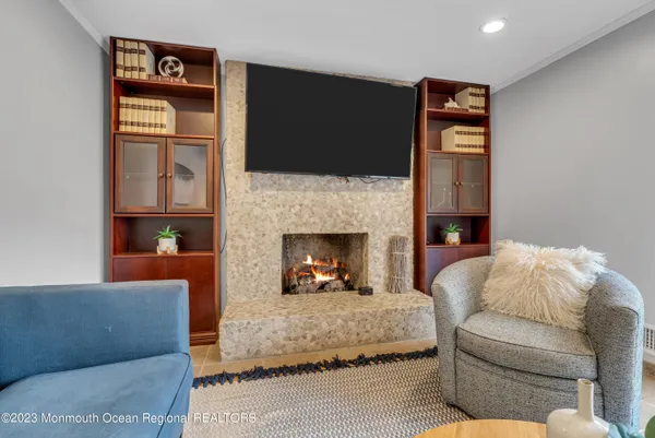 a living room with furniture fireplace and flat screen tv