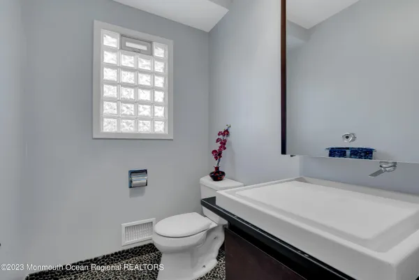 a bathroom with a sink toilet and window