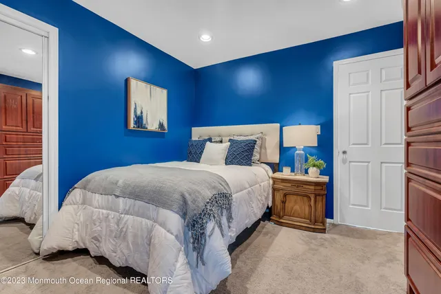 a bed sitting in a spacious bedroom next to a window