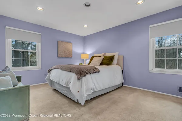 a bedroom with a bed and glass window