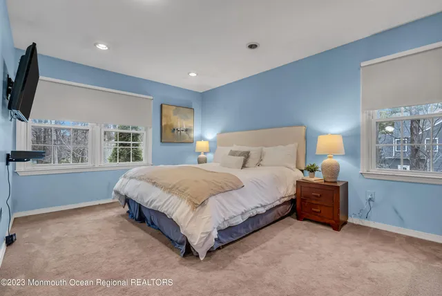 a spacious bedroom with a bed and a large window