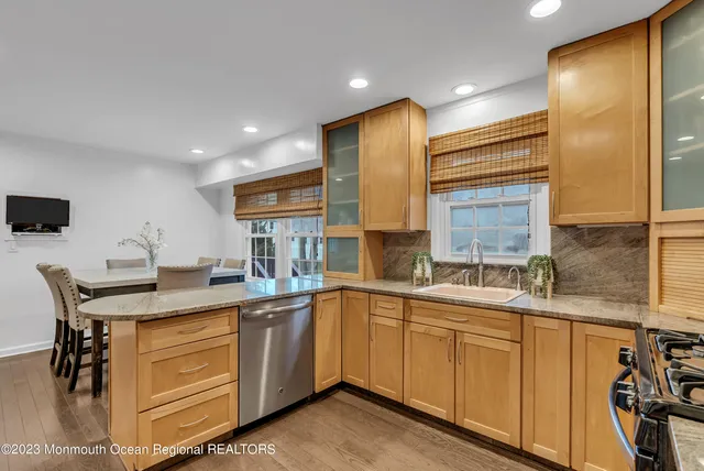 a kitchen with a sink a stove and cabinets