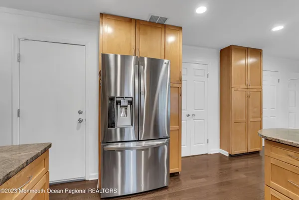 a metallic refrigerator freezer sitting in a kitchen