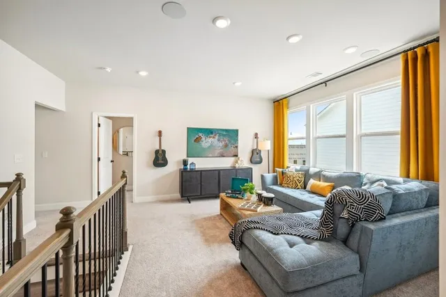 a living room with furniture and a large window