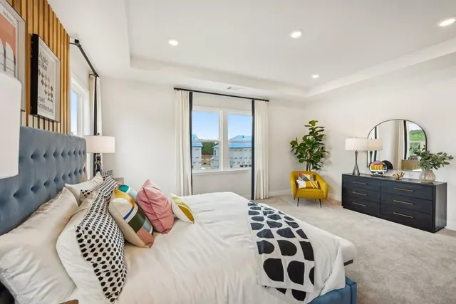 a bedroom with a bed and mirror