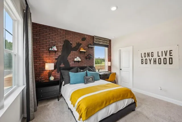 a bed sitting in a bedroom next to a window