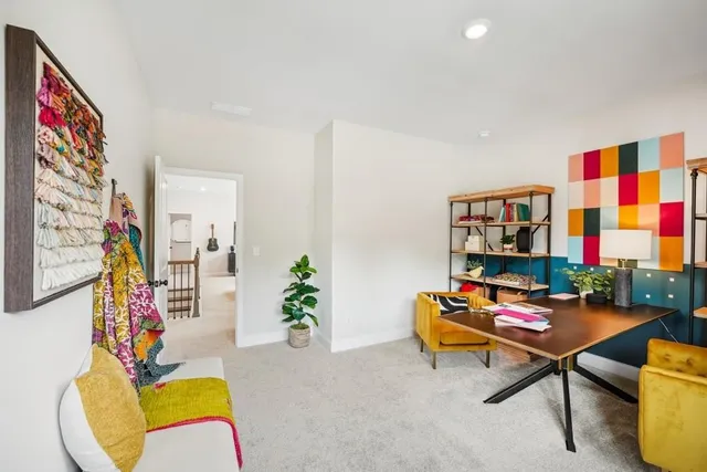 a living room with furniture and paintings on the wall