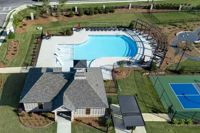 an aerial view of a house with swimming pool garden and patio