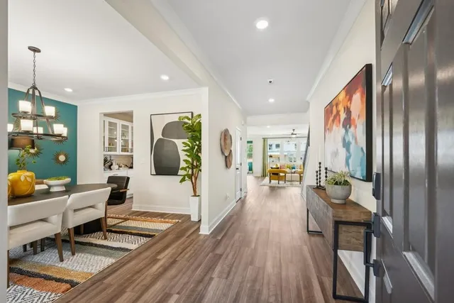 a living room with furniture and wooden floor