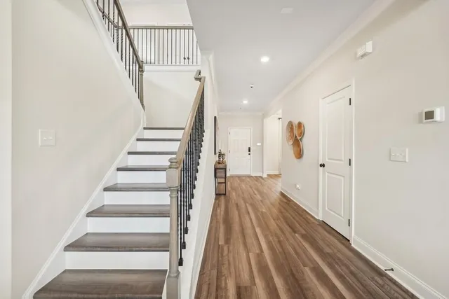 a view of entryway with wooden floor and stairs
