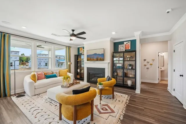 a living room with furniture a fireplace and a chandelier