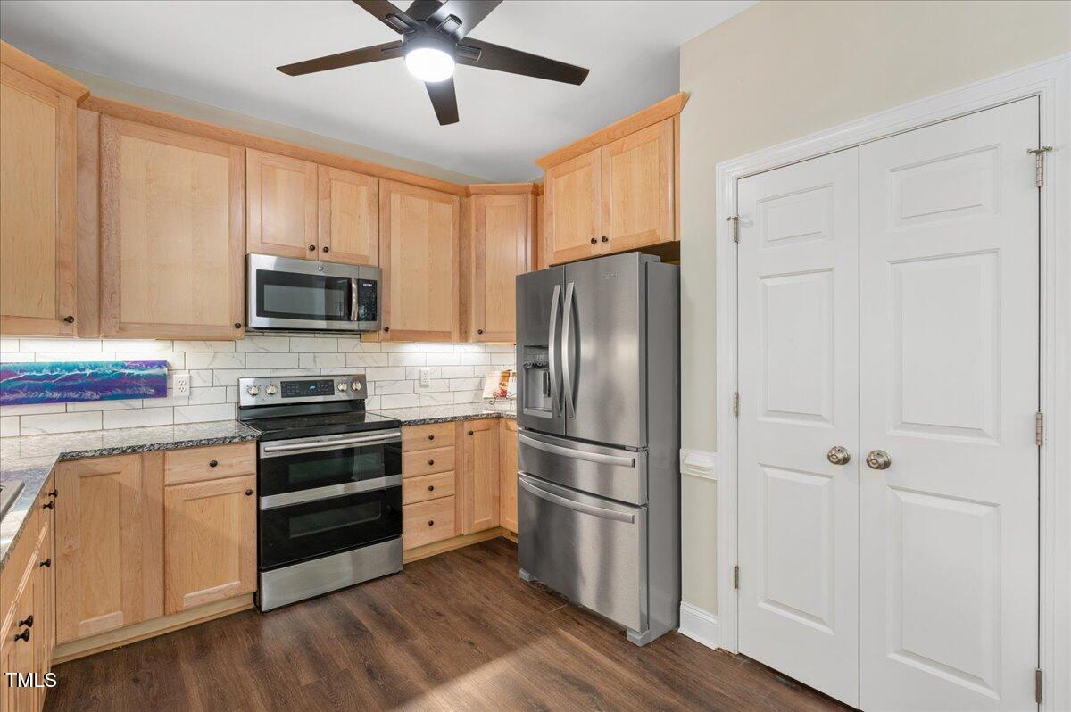7805 Tuscan Ridge Drive Wendell, NC 27591 - Photo 11 of 40 a kitchen with cabinets stainless steel appliances and a window