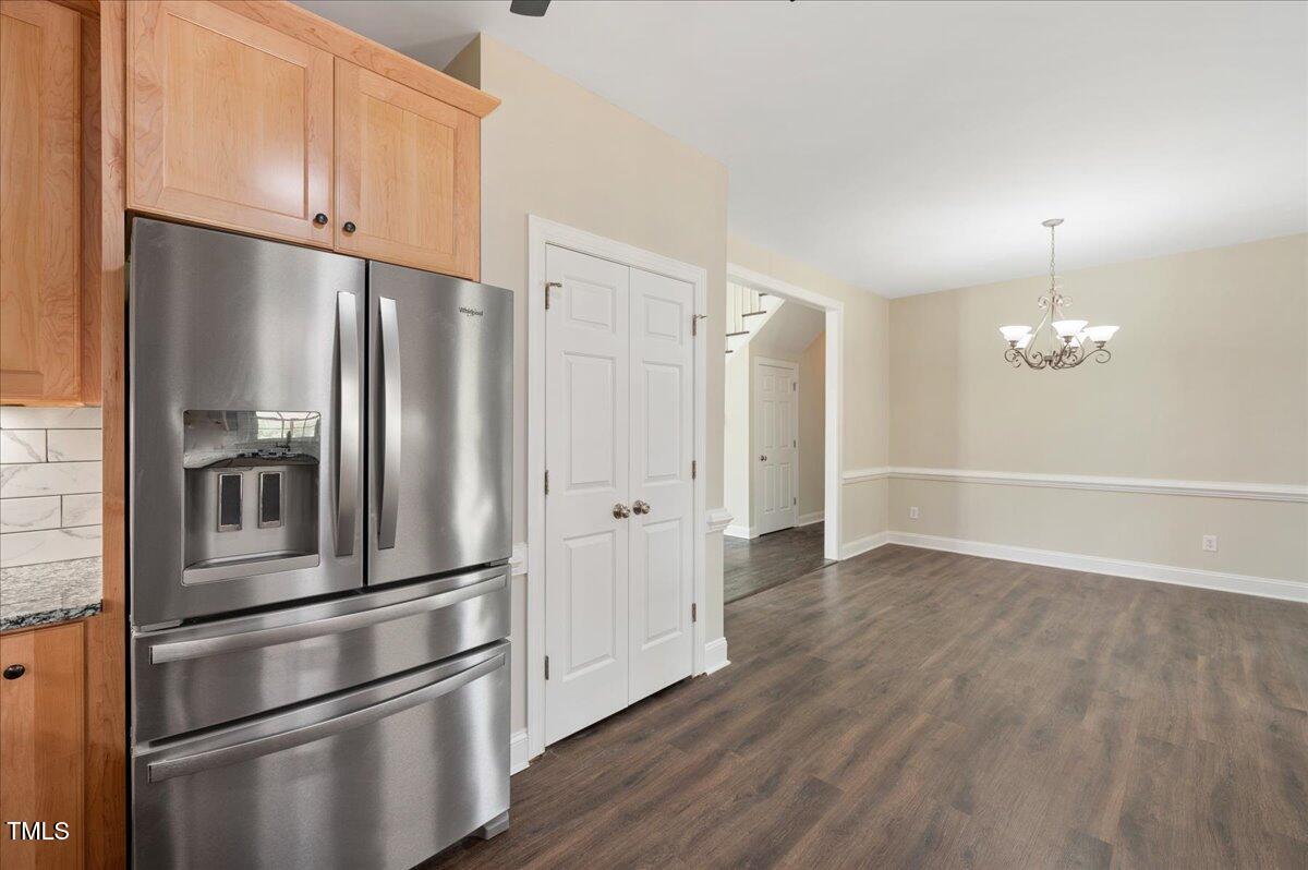 7805 Tuscan Ridge Drive Wendell, NC 27591 - Photo 13 of 40 a view of kitchen with stainless steel appliances wooden floor and staircase