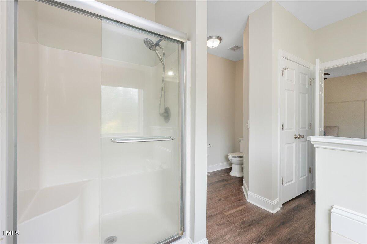 7805 Tuscan Ridge Drive Wendell, NC 27591 - Photo 18 of 40 a bathroom with a glass shower door