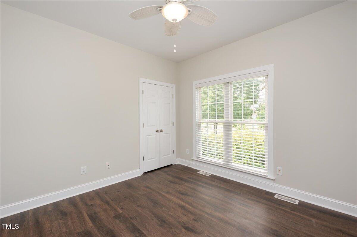 7805 Tuscan Ridge Drive Wendell, NC 27591 - Photo 19 of 40 an empty room with wooden floor and windows