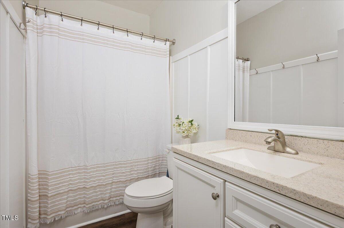 7805 Tuscan Ridge Drive Wendell, NC 27591 - Photo 20 of 40 a bathroom with a sink a toilet and shower