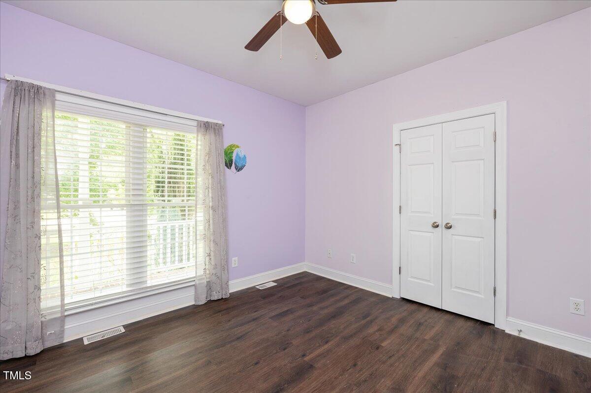 7805 Tuscan Ridge Drive Wendell, NC 27591 - Photo 21 of 40 a view of an empty room with wooden floor and window