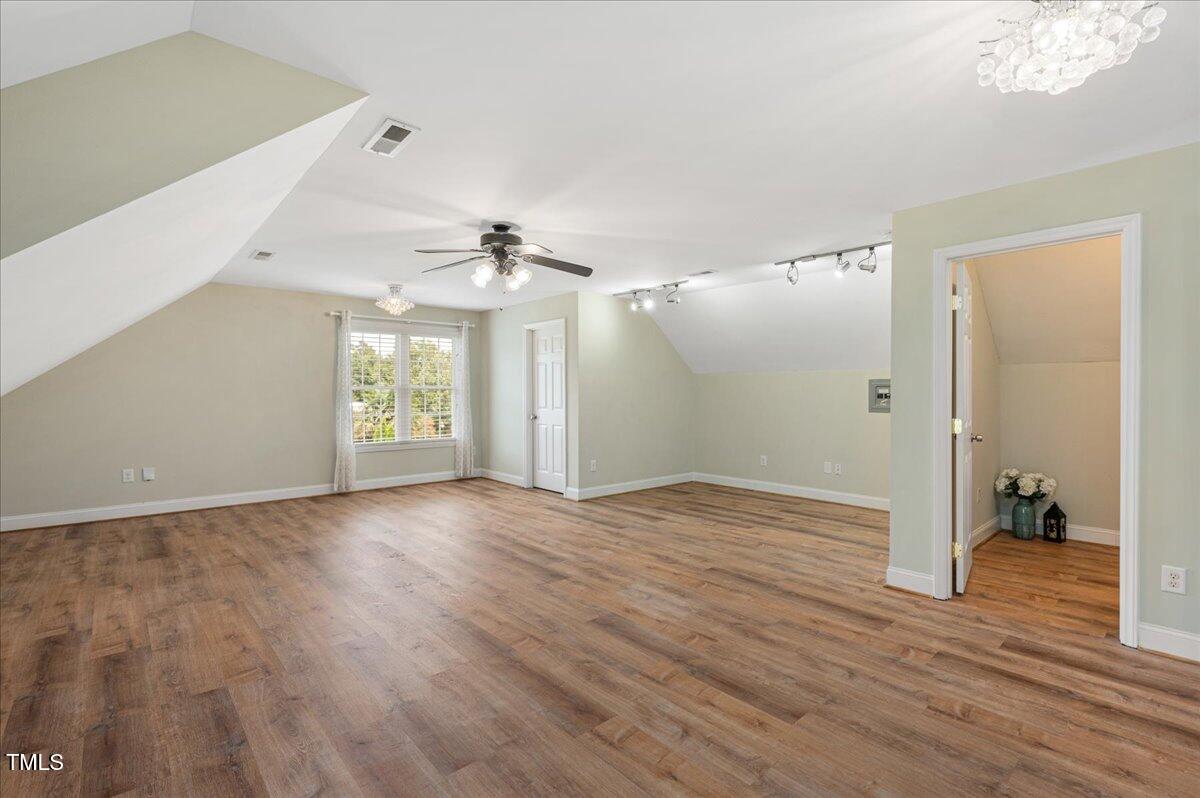 7805 Tuscan Ridge Drive Wendell, NC 27591 - Photo 23 of 40 a view of empty room with wooden floor and fan