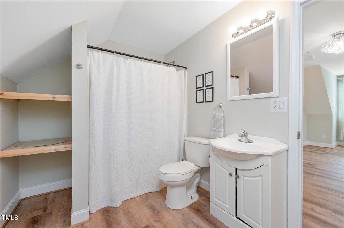 7805 Tuscan Ridge Drive Wendell, NC 27591 - Photo 24 of 40 a bathroom with a sink a toilet and mirror