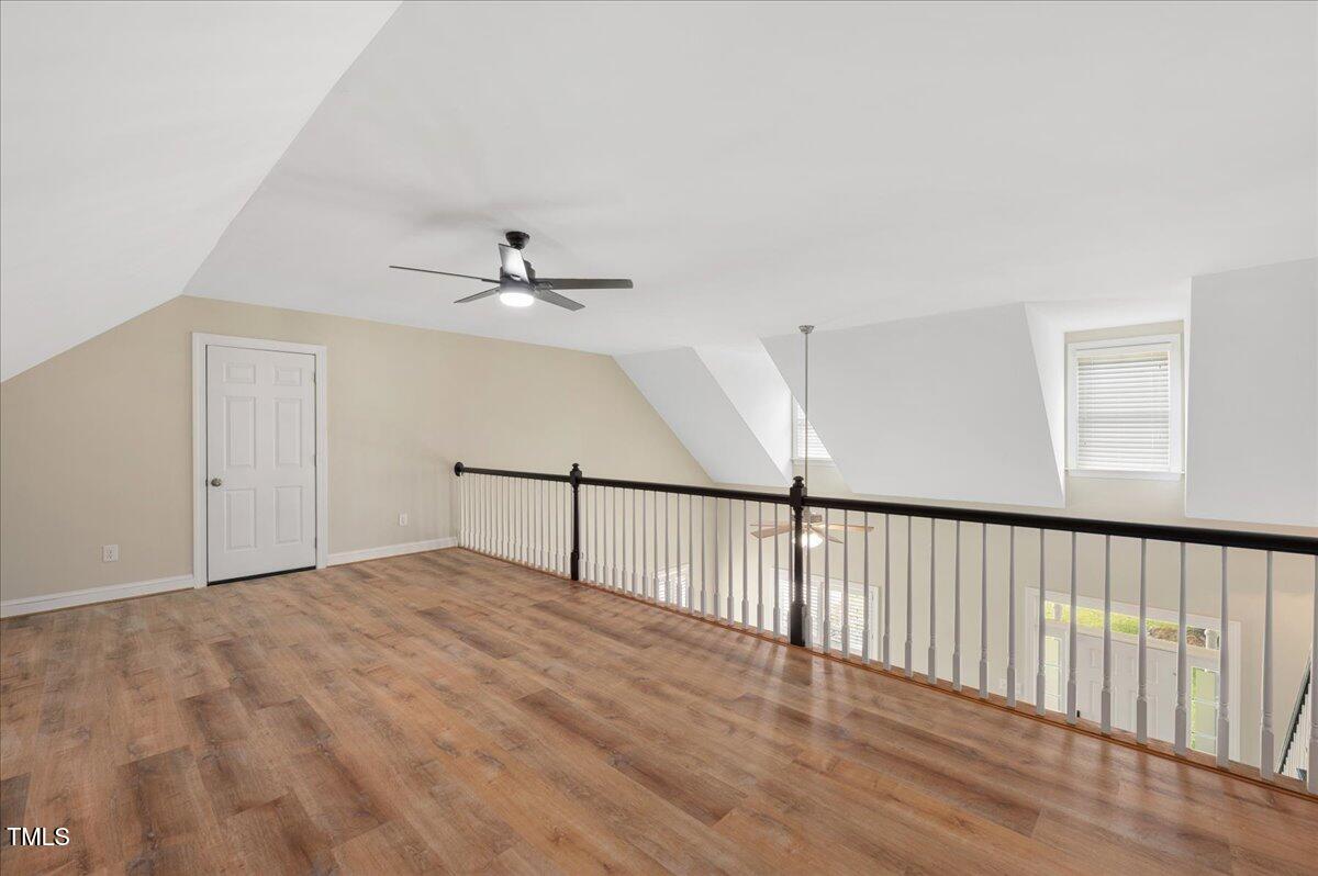 7805 Tuscan Ridge Drive Wendell, NC 27591 - Photo 26 of 40 a view of an empty room with wooden floor