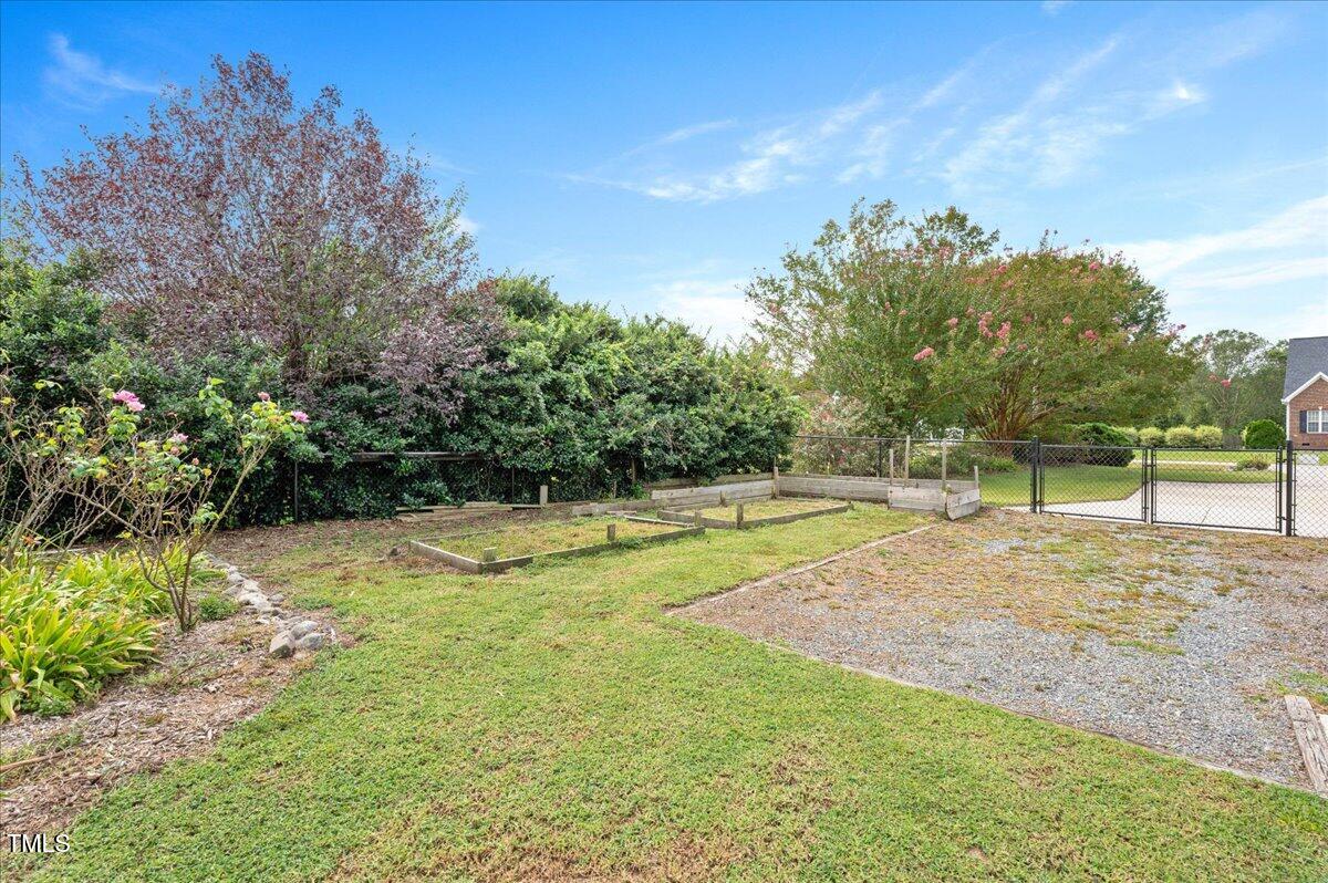 7805 Tuscan Ridge Drive Wendell, NC 27591 - Photo 34 of 40 a view of a backyard with large trees