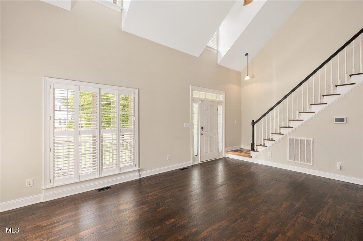 7805 Tuscan Ridge Drive Wendell, NC 27591 - Photo 7 of 40 a view of an empty room with wooden floor and a window