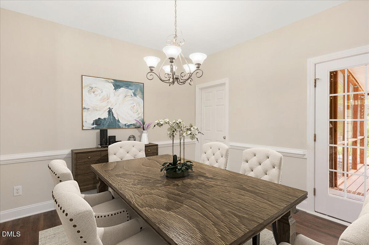 7805 Tuscan Ridge Drive Wendell, NC 27591 - Photo 8 of 40 a view of a dining room with furniture a chandelier and wooden floor