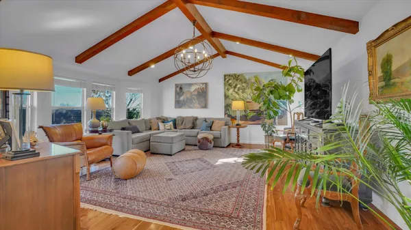 a living room with patio furniture and a large window