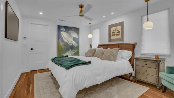 a bedroom with a bed and a chandelier