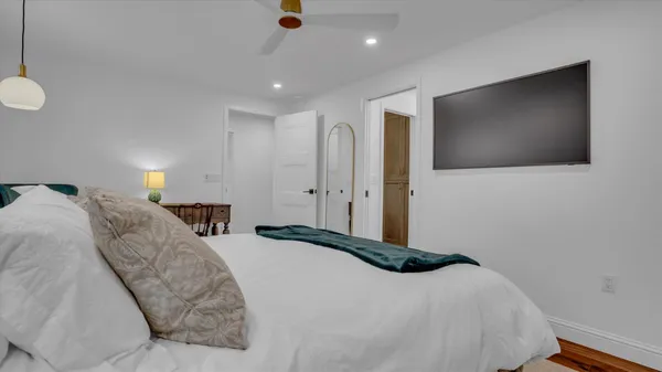 a bedroom with a bed and a flat screen tv