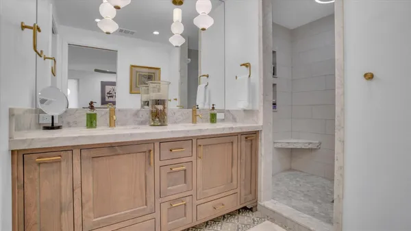 a bathroom with a granite countertop sink a toilet and a mirror