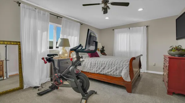 a bedroom with bed and a chandelier