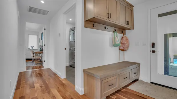 a kitchen with stainless steel appliances cabinets and wooden floor