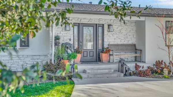 a front view of a house with outdoor seating