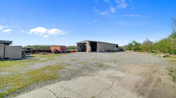 an aerial view of a house with a garden and lake view