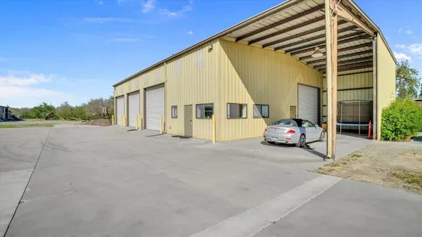 a view of a workspace with furniture and a large window