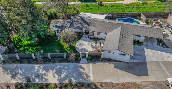 an aerial view of a house with outdoor space